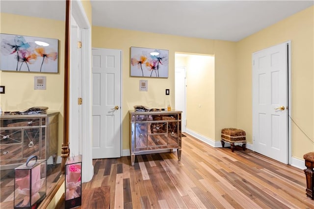 interior space with baseboards and wood finished floors