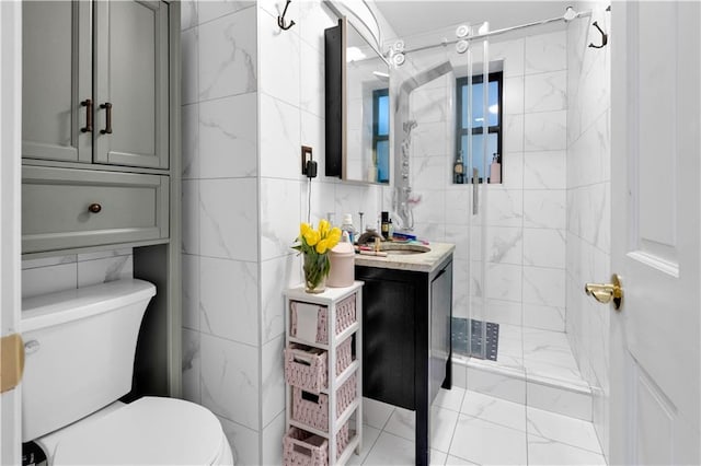 full bath featuring toilet, marble finish floor, tile walls, a shower stall, and vanity