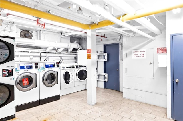 community laundry room with stacked washer / drying machine and washing machine and clothes dryer