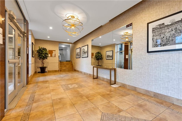 corridor featuring light tile patterned floors, a notable chandelier, recessed lighting, and stairs