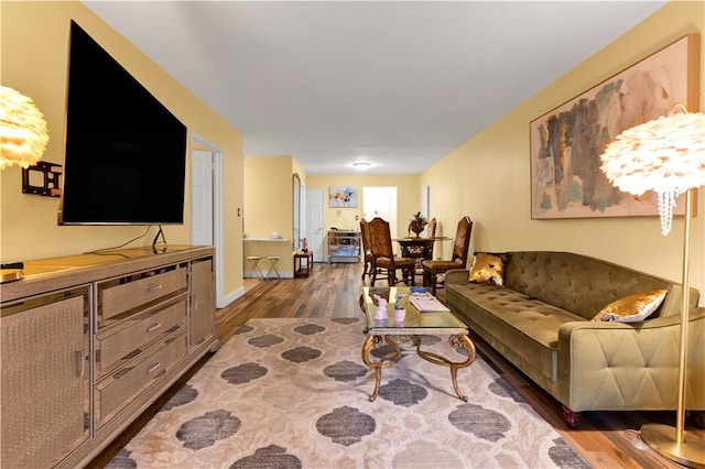 living room featuring baseboards and wood finished floors