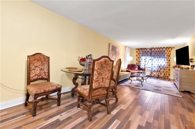 sitting room featuring baseboards and wood finished floors