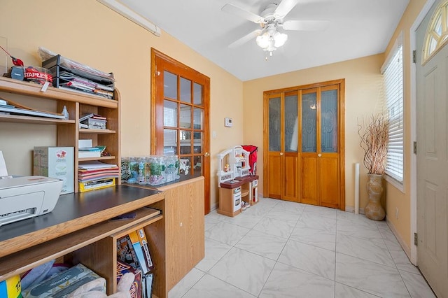 entrance foyer with marble finish floor and a ceiling fan