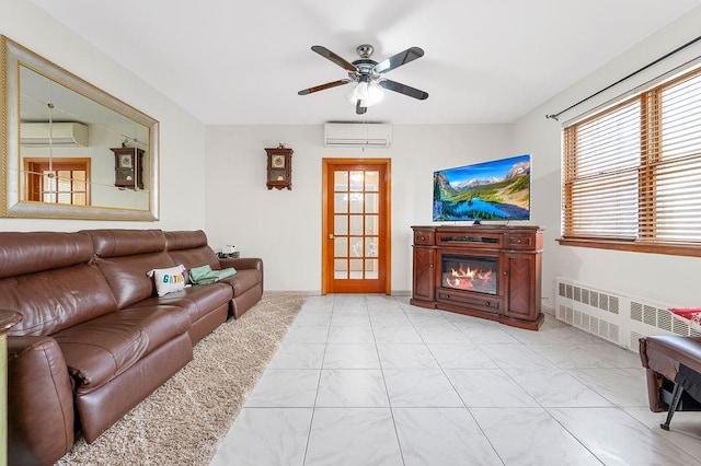 living room with a glass covered fireplace, radiator, ceiling fan, and a wall mounted AC