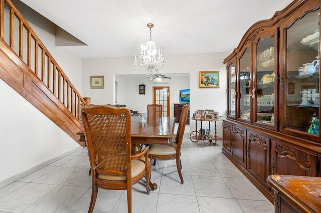 dining space with stairway and ceiling fan with notable chandelier