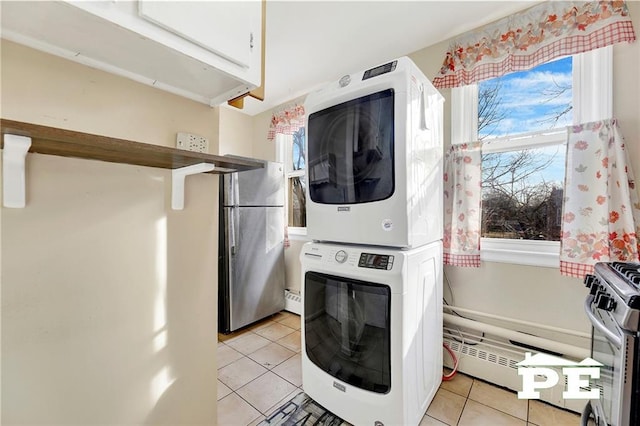 1722 E 55th St Unit 35F, Brooklyn, NY 11234 - clothes washing area featuring stacked washer / drying machine, light tile patterned flooring, and a baseboard radiator