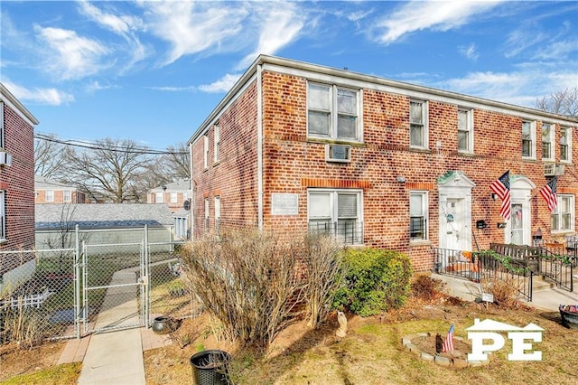1722 E 55th St Unit 35F, Brooklyn, NY 11234 - townhome / multi-family property featuring a gate, brick siding, fence, and a wall mounted AC