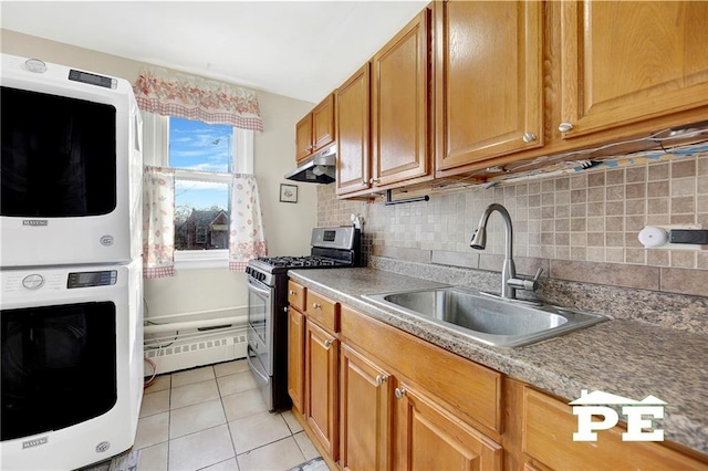 1722 E 55th St Unit 35F, Brooklyn, NY 11234 - kitchen featuring stainless steel range with gas cooktop, under cabinet range hood, stacked washer and clothes dryer, a sink, and light tile patterned flooring