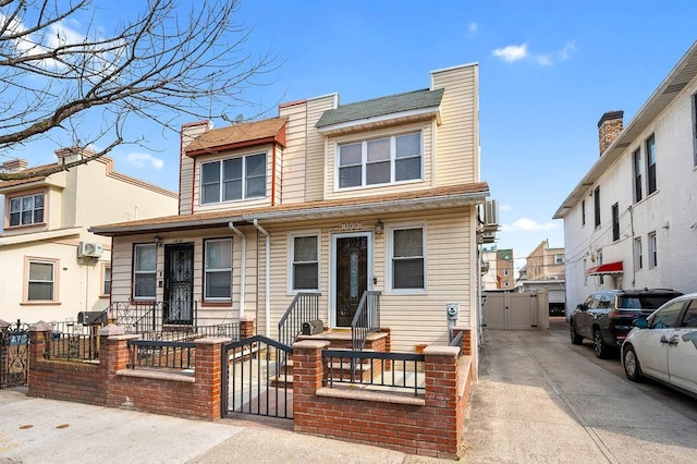 multi unit property with a fenced front yard, a chimney, and a gate