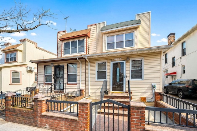 townhome / multi-family property with a fenced front yard and a chimney