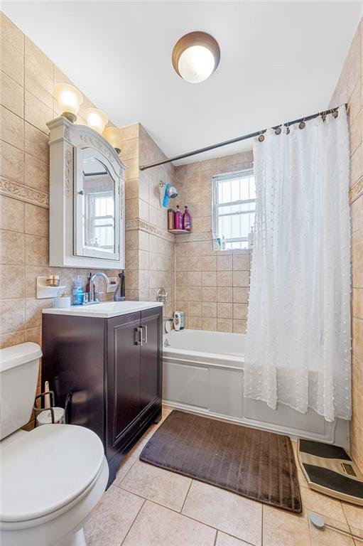 bathroom featuring vanity, shower / tub combo, tile walls, toilet, and tile patterned floors