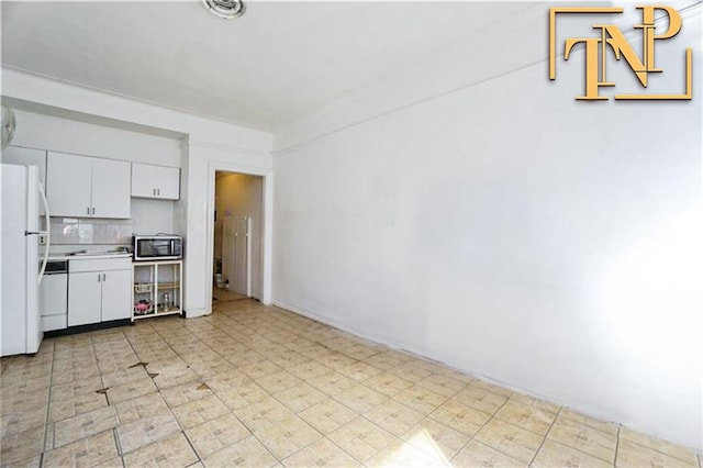 kitchen with backsplash, white cabinets, white appliances, and light countertops