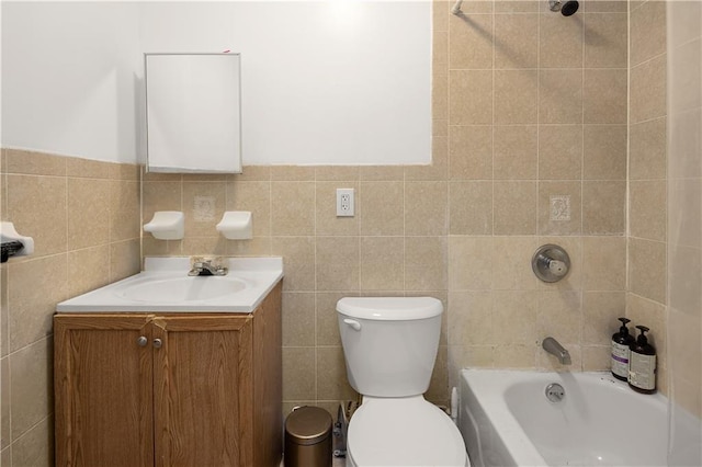 bathroom with toilet, tile walls, bathtub / shower combination, and vanity