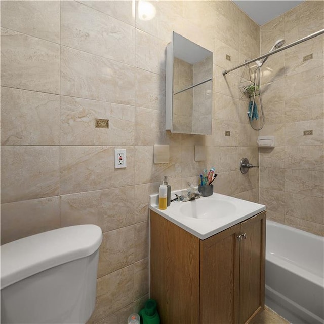 bathroom with tub / shower combination, toilet, tile walls, and vanity