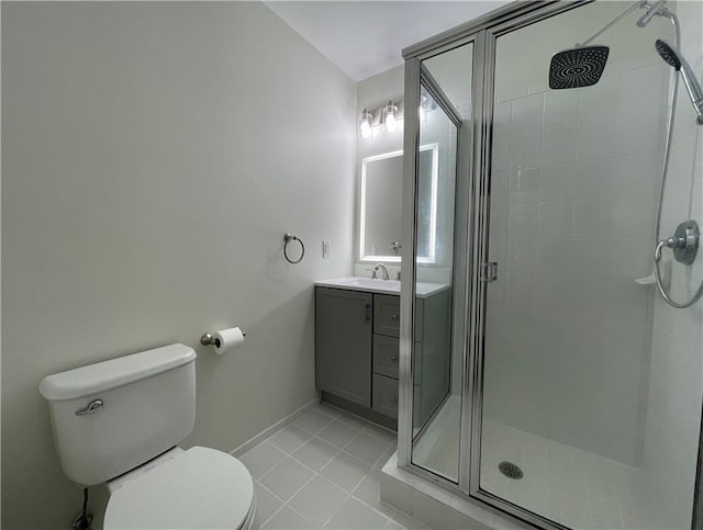 full bathroom with a shower stall, baseboards, toilet, tile patterned floors, and vanity