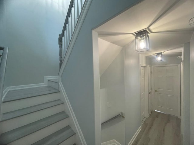 stairs featuring wood finished floors