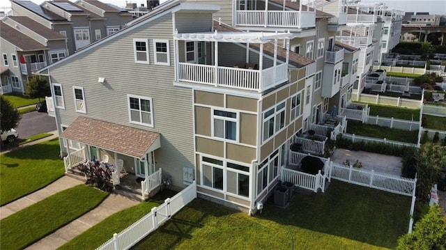 view of property featuring central air condition unit, a residential view, and fence