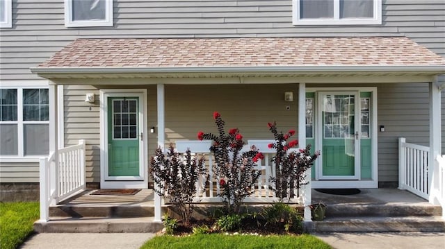 entrance to property with a shingled roof