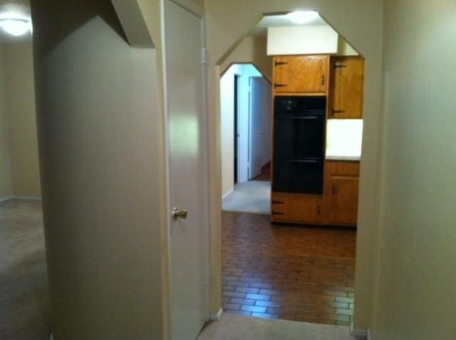 corridor featuring brick floor