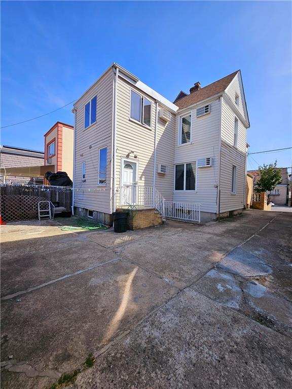 rear view of house with fence