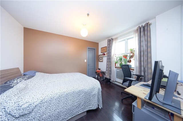 bedroom with dark wood-style flooring