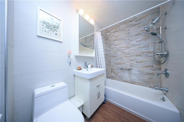 bathroom featuring vanity, toilet, shower / tub combo with curtain, and wood finished floors