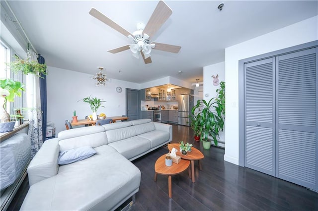 living room with dark wood-type flooring and ceiling fan