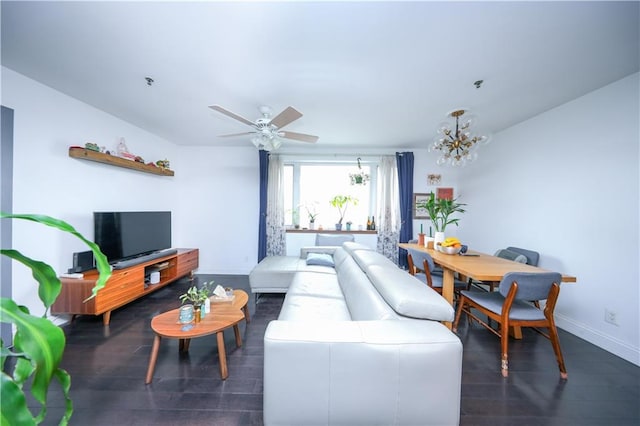 living area featuring a ceiling fan, baseboards, and wood finished floors