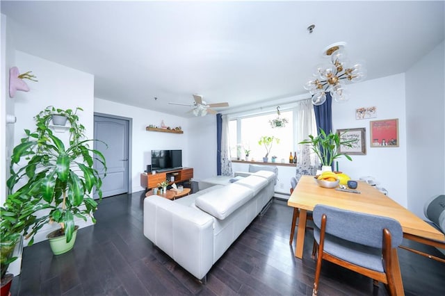 living room featuring a baseboard heating unit, dark wood-type flooring, and ceiling fan with notable chandelier