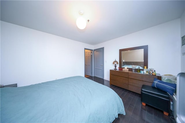 bedroom featuring dark wood-style flooring