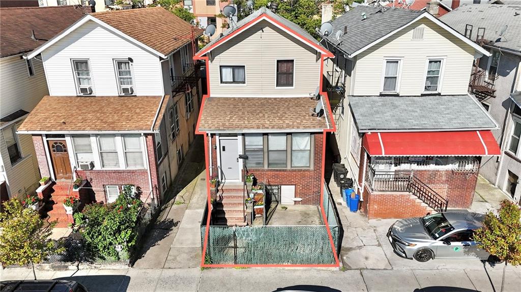 3048 Brighton 4th St, Brooklyn, NY 11235 - traditional-style house featuring a residential view, entry steps, brick siding, and a shingled roof