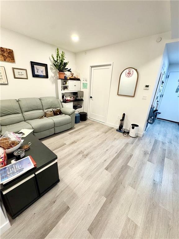 living room featuring baseboards and wood finished floors