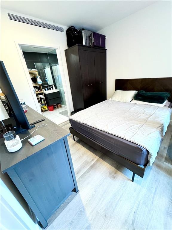 bedroom featuring visible vents and light wood-style floors