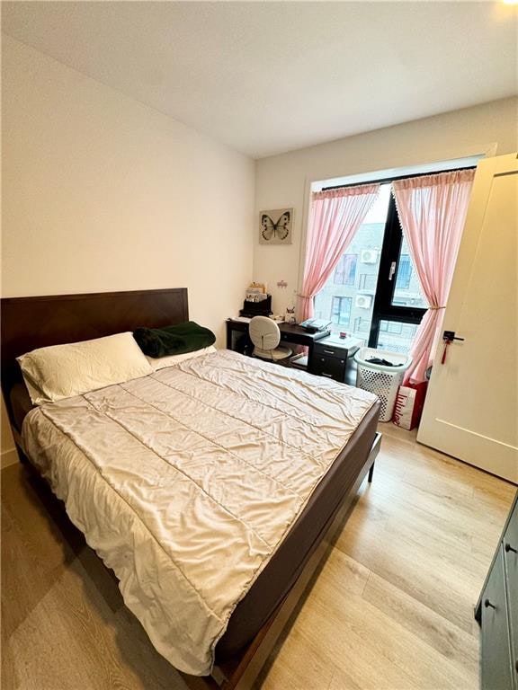 bedroom featuring light wood-style flooring