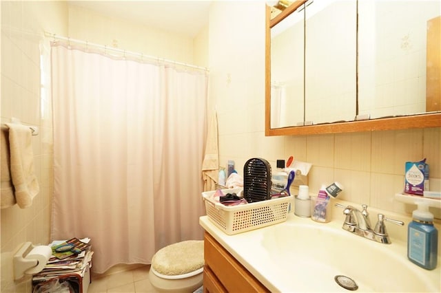 bathroom featuring tile walls, toilet, a shower with shower curtain, tile patterned flooring, and vanity