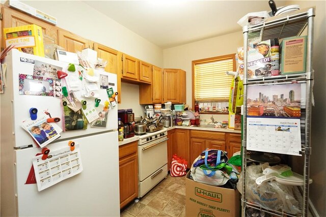 kitchen with white appliances, light countertops, and a sink