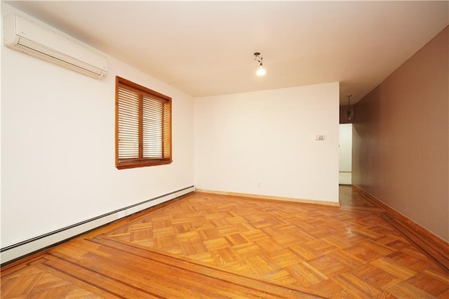 spare room featuring an AC wall unit, a baseboard radiator, and baseboards