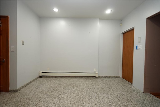 empty room with a baseboard radiator and recessed lighting