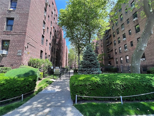 view of home's community with a gate and fence