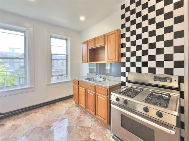 1708 Linden St, Ridgewood, NY 11385 - kitchen with gas range, light stone finish floors, light countertops, brown cabinets, and recessed lighting