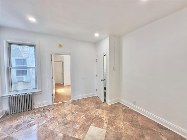 1708 Linden St, Ridgewood, NY 11385 - spare room with radiator heating unit, stone finish flooring, and recessed lighting