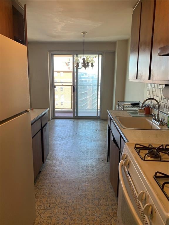 2652 Cropsey Ave Unit 15K, Brooklyn, NY 11214 - kitchen featuring white appliances, a chandelier, light countertops, decorative light fixtures, and tasteful backsplash