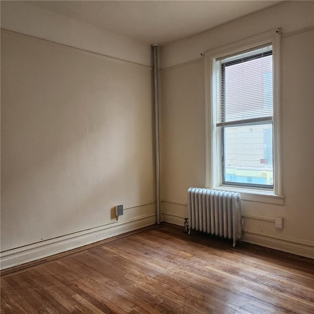 590 Parkside Ave Unit 2Be, Brooklyn, NY 11226 - spare room with radiator, wood finished floors, and baseboards