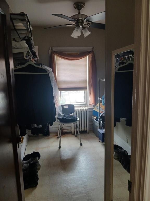 bedroom featuring radiator, tile patterned floors, and ceiling fan