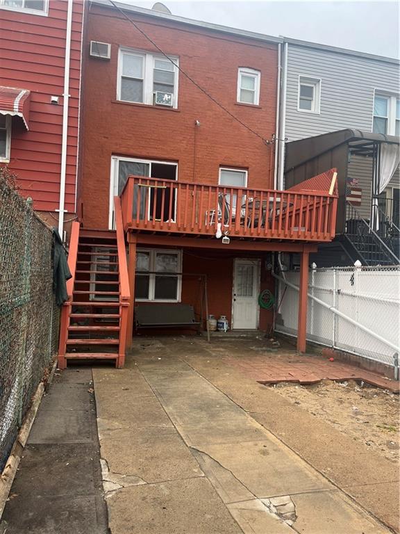 rear view of house with stairway and a wooden deck