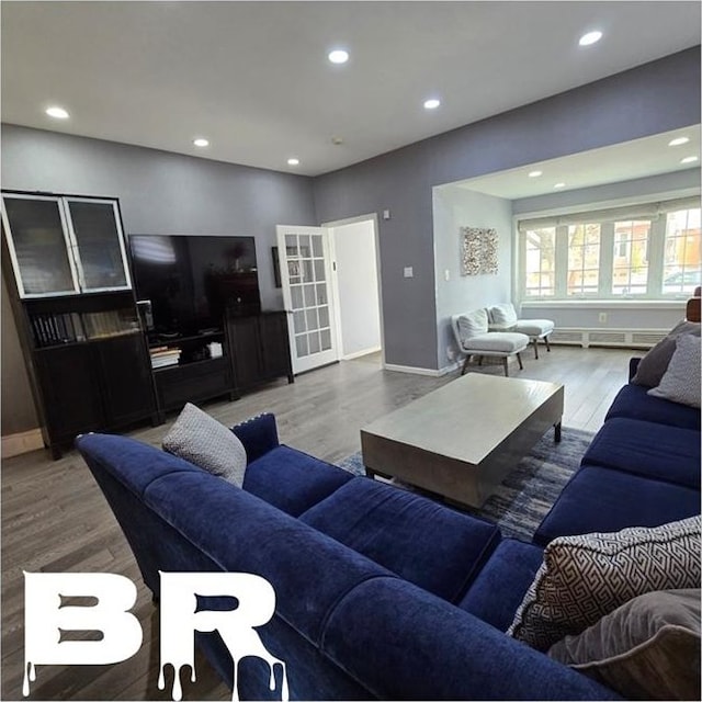 living area featuring wood finished floors, recessed lighting, baseboards, and baseboard heating