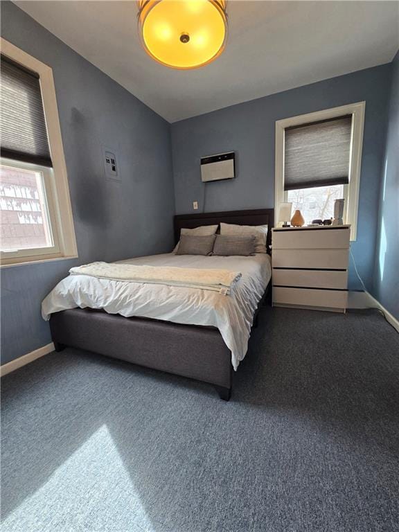 bedroom with carpet, multiple windows, and baseboards