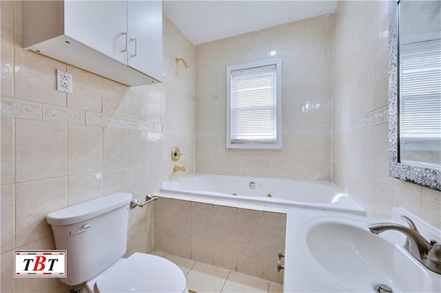 bathroom featuring tile walls, a sink, a jetted tub, tile patterned flooring, and toilet