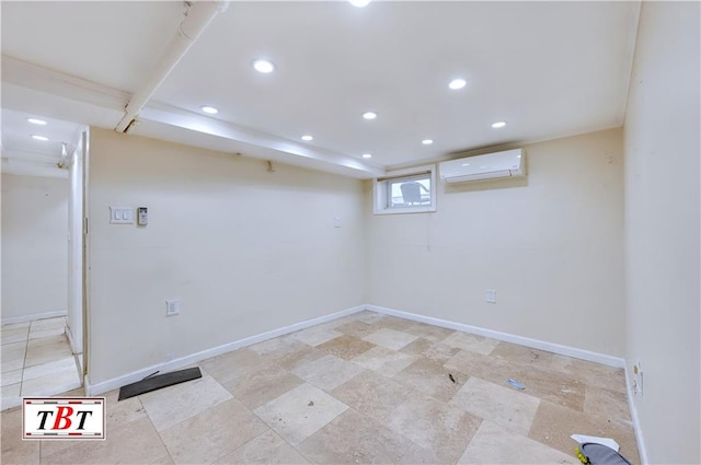 below grade area with an AC wall unit, recessed lighting, and baseboards