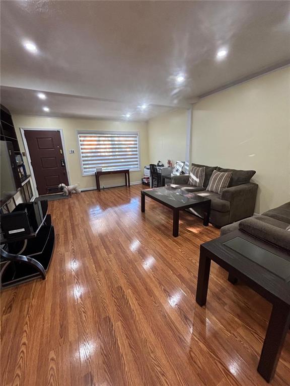 living room with recessed lighting and wood finished floors